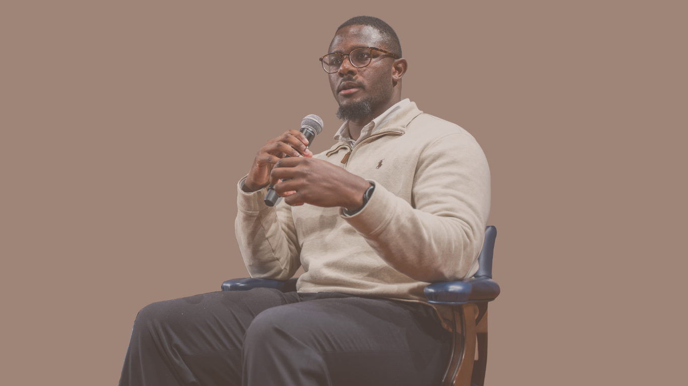 Dr. James Frater speaking into a microphone